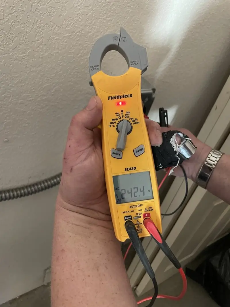 Voltage testing with clamp meter during Ceiling Fan Installation in Holly Ridge